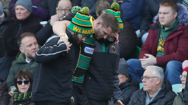 Dan Biggar is helped off the field during Northampton Saints v Saracens match