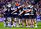 Scotland players in a huddle during match against France in 2024 Six Nations